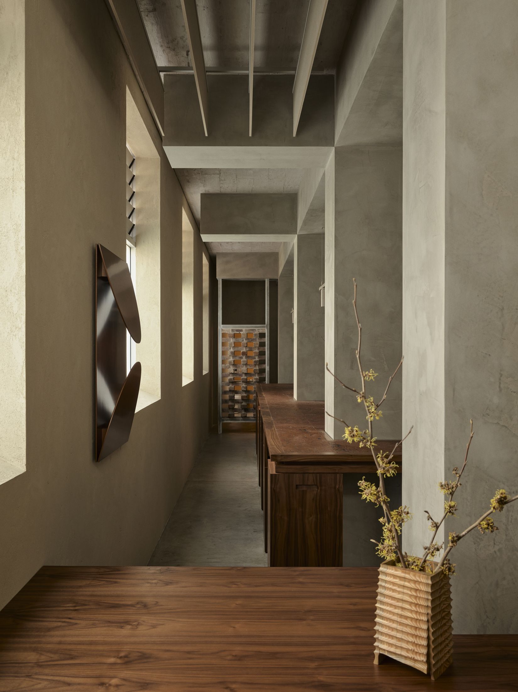 Walnut joinery and the long bar table at Cinderella Deep