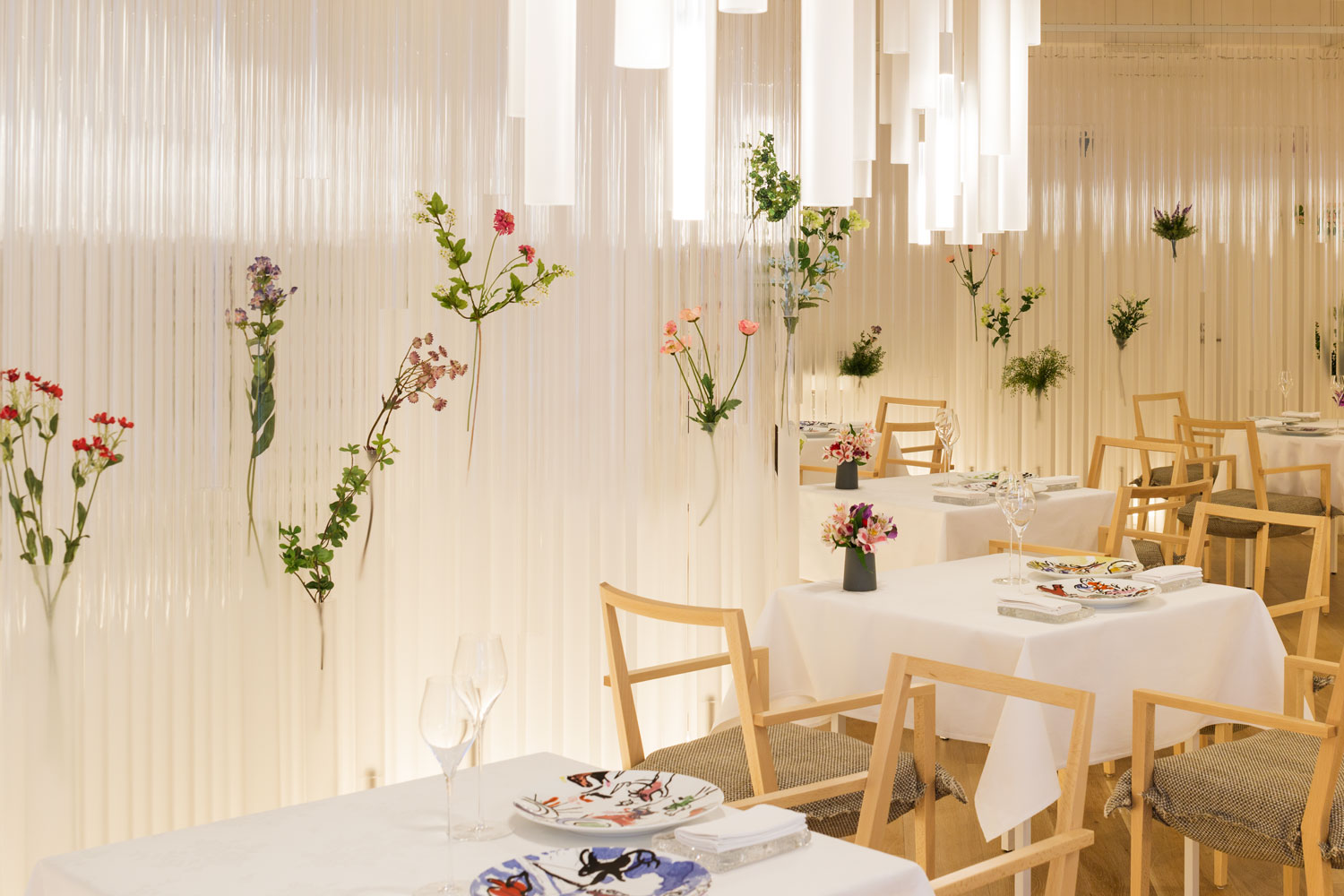 Opaque and clear cylinders mixed through the curtain, diffusing light into the dining area