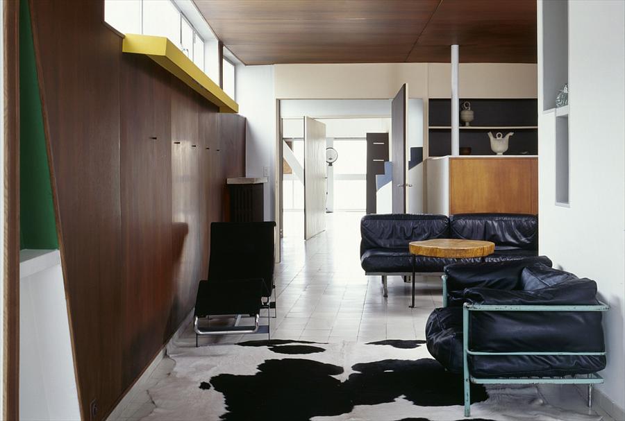 The studio on the top floor, with the party wall left as found stone and the plywood cabinet standing free of it