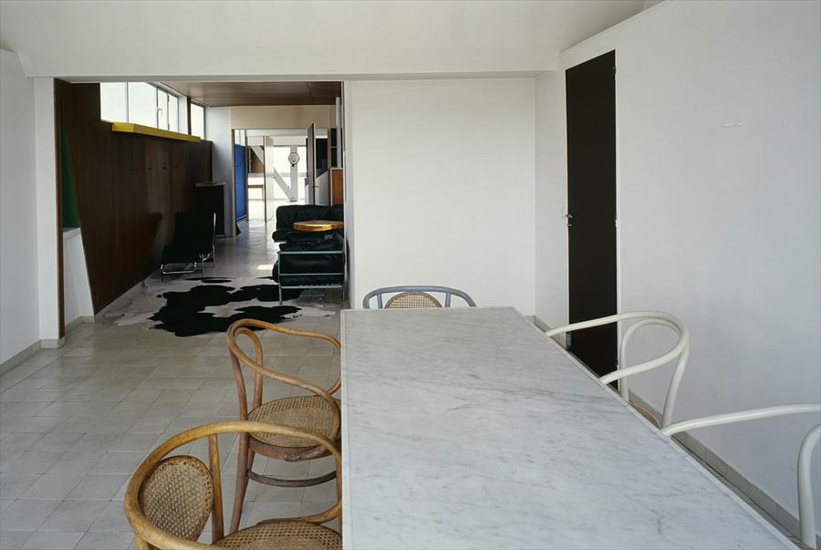 The living floor of the architect's own apartment, with the furniture he designed sitting on a cowhide beside the plywood screen