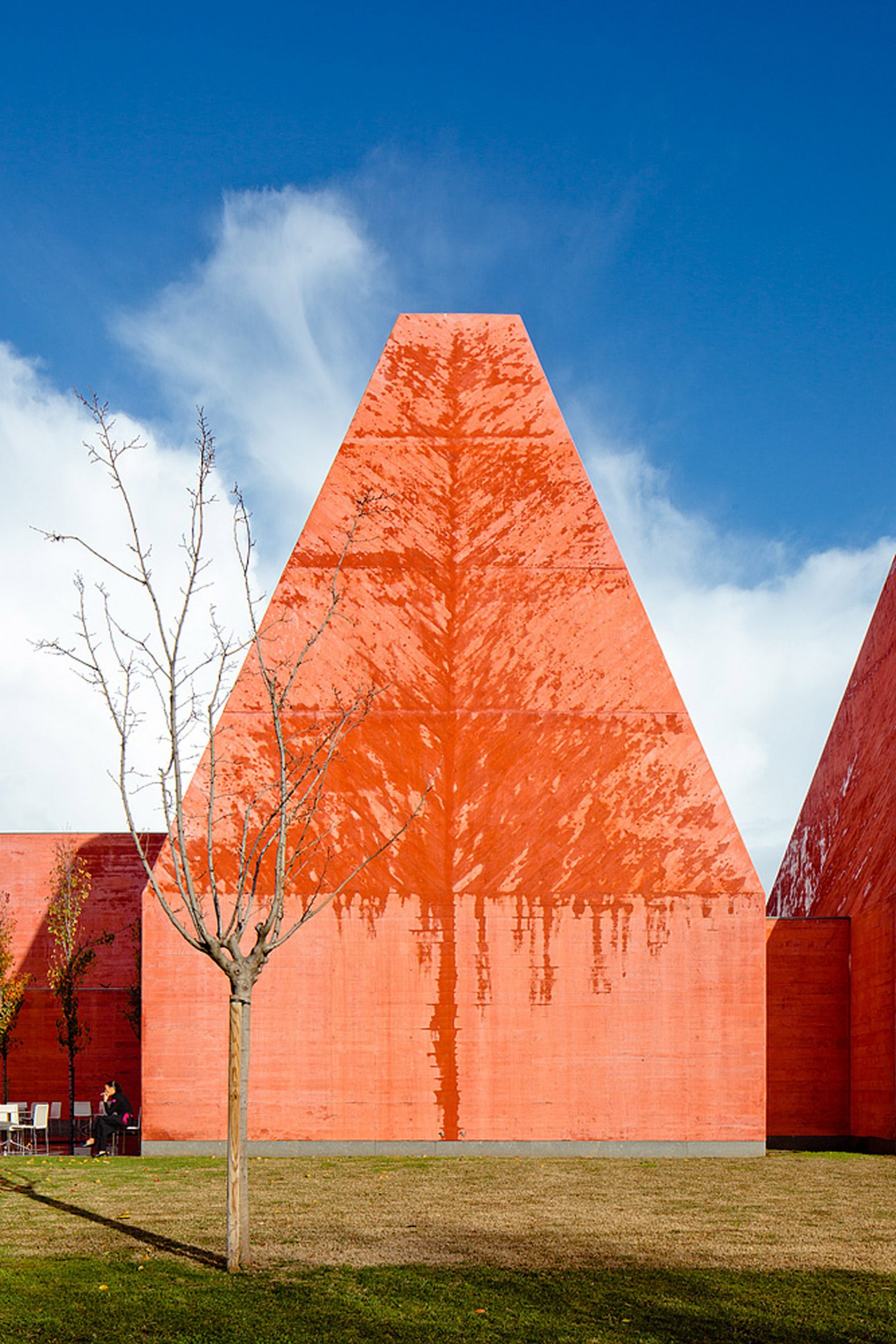 One of the pyramidal towers seen from below, cast concrete against sky
