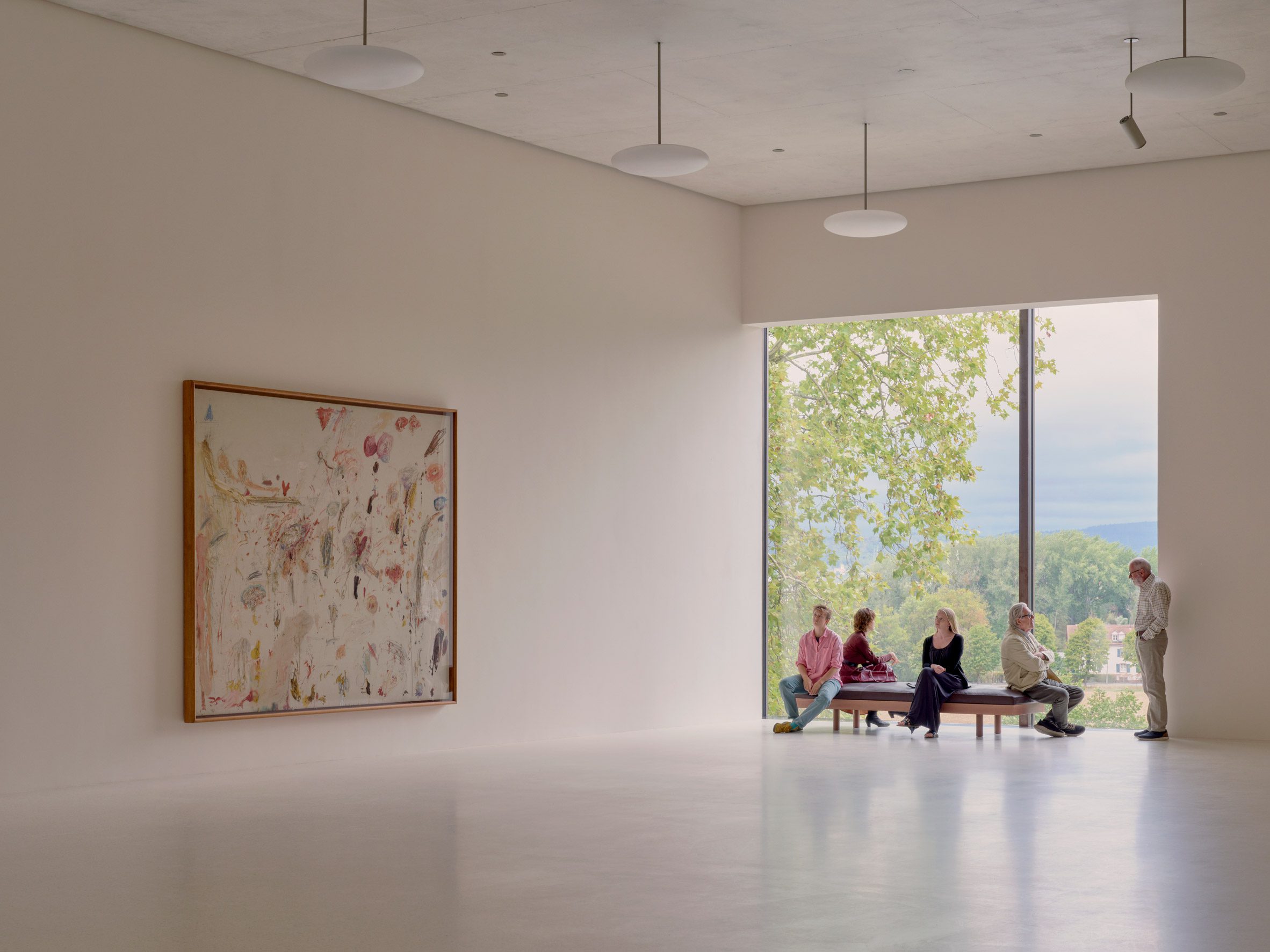 Large windows in the gallery give views of the treetops