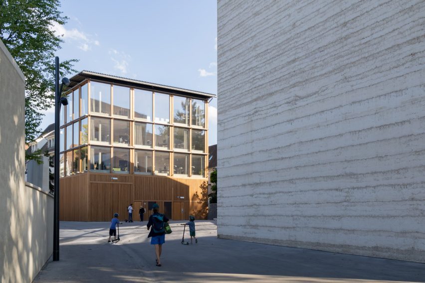Timber cladding lines the lower portion of the Erlen Torhaus building