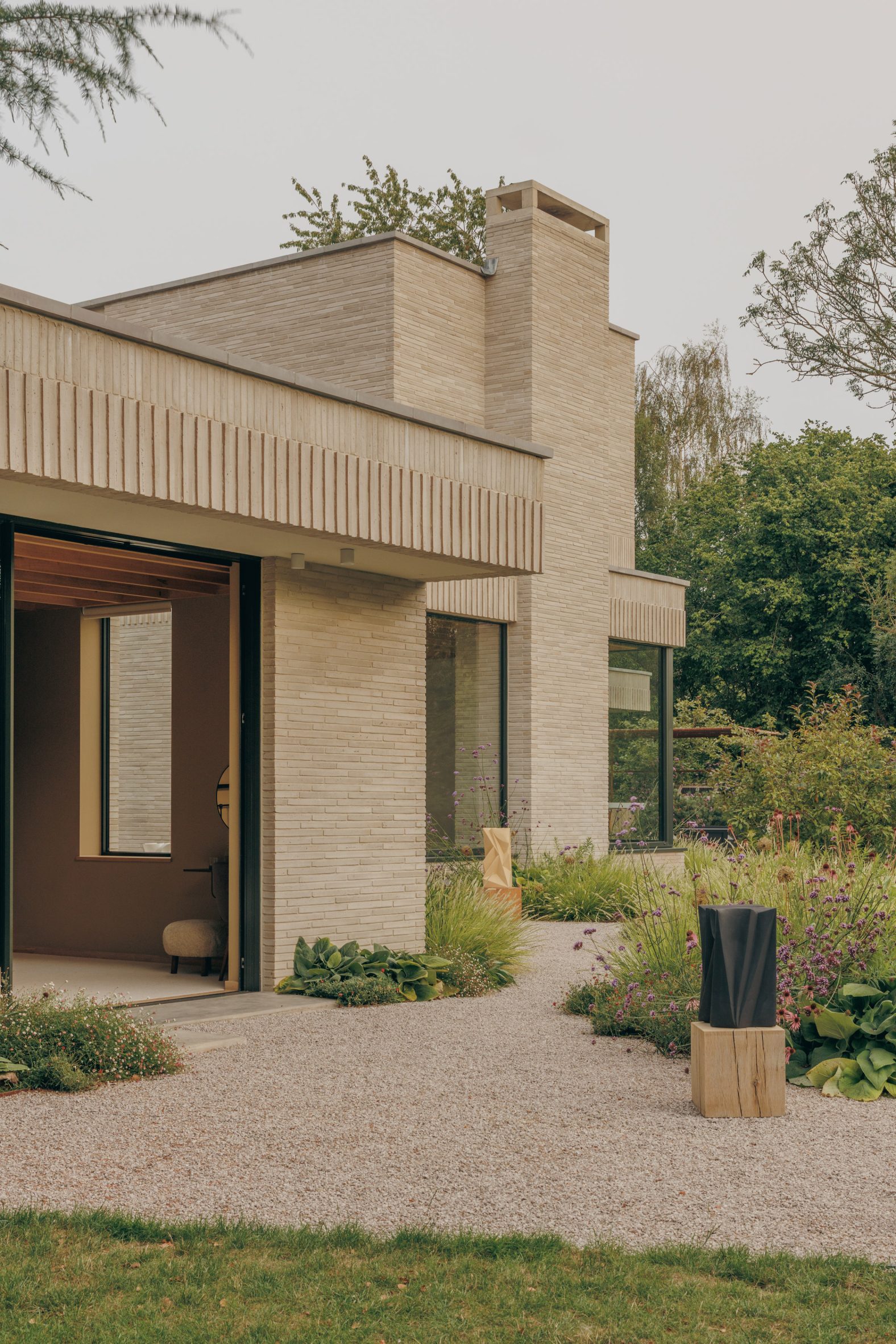 Warm grey Danish brick, turned course by course so the light has something to do all day.