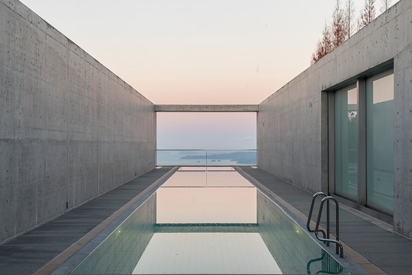 Interior with a long opening framing water and sky