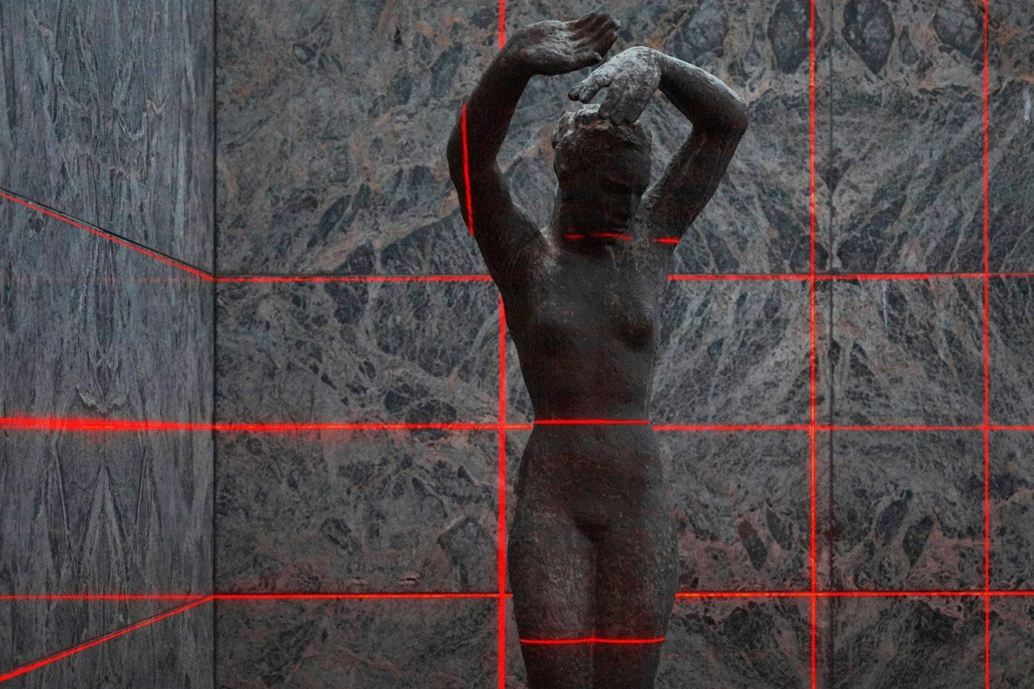 The grid reading across chromed columns and the glazed wall at night