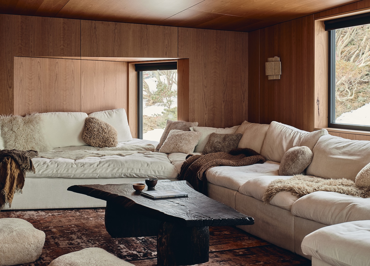 Low, restful light through the lodge, shadow held as part of the palette