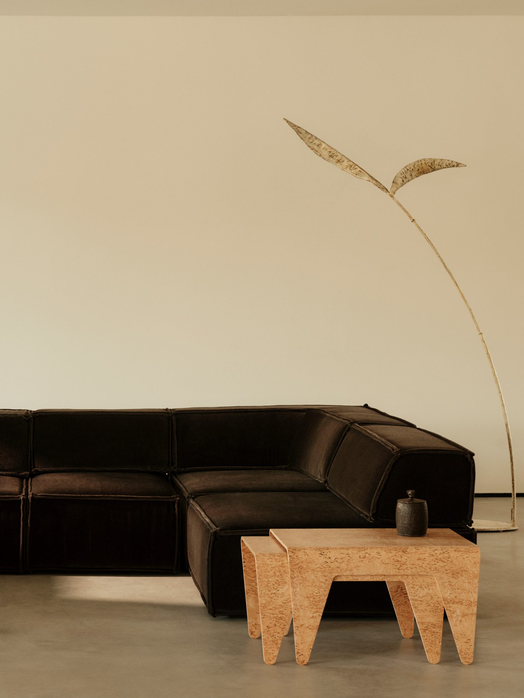 A masur birch Isokon table beside a sofa in the gallery