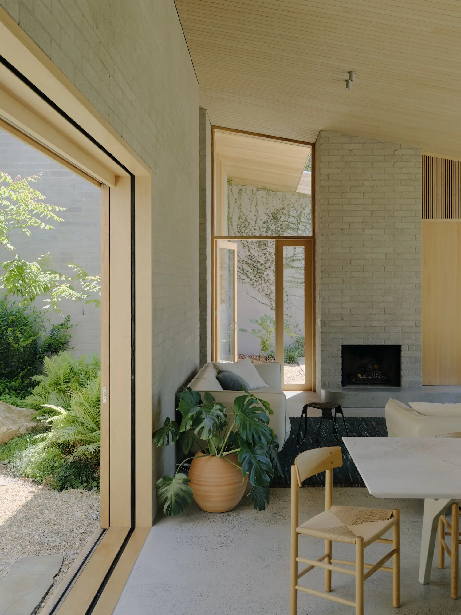 Split levels trace the steep site and open to the landscaped courtyards