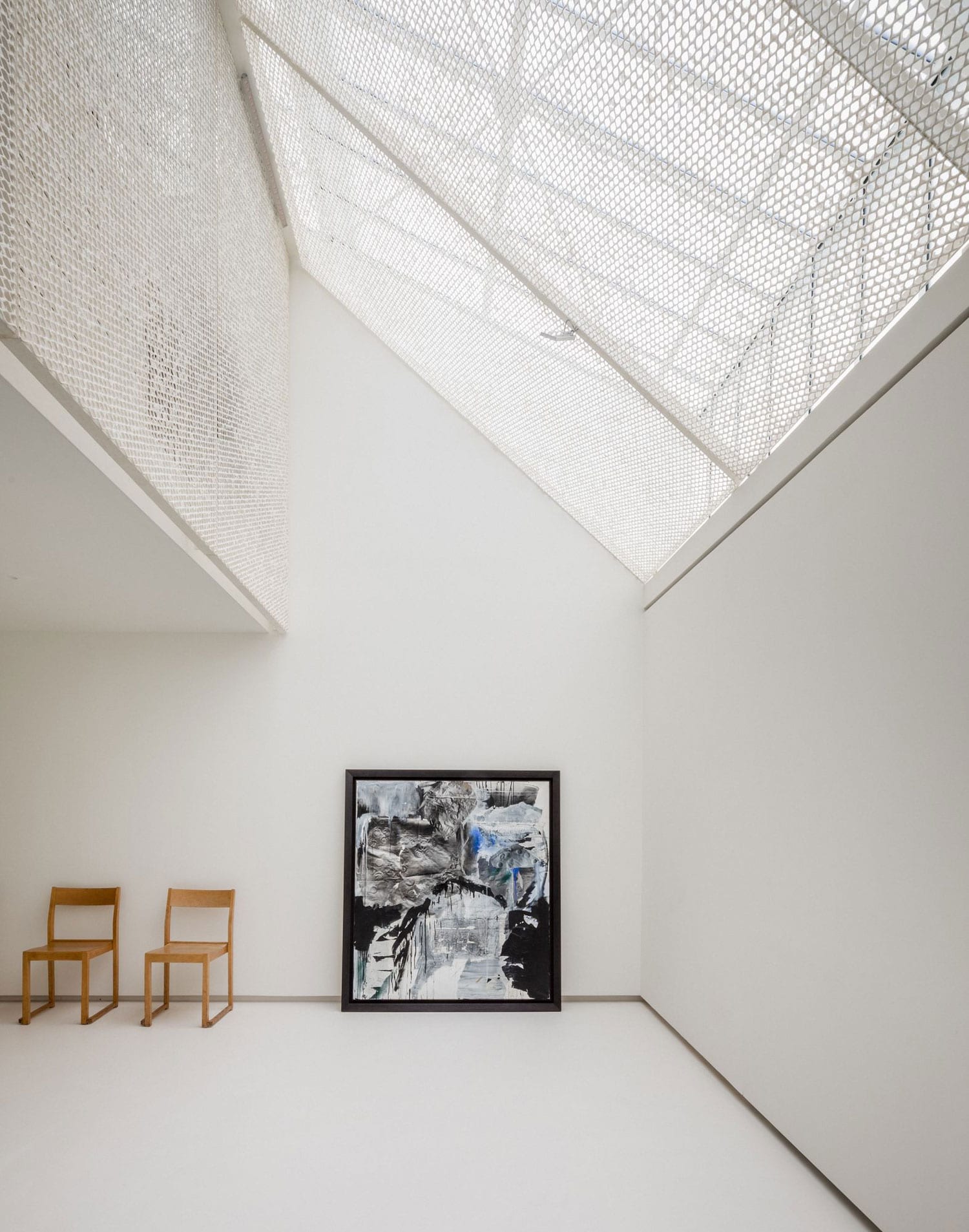 The washi screen around the central stair, lit from the skylight above