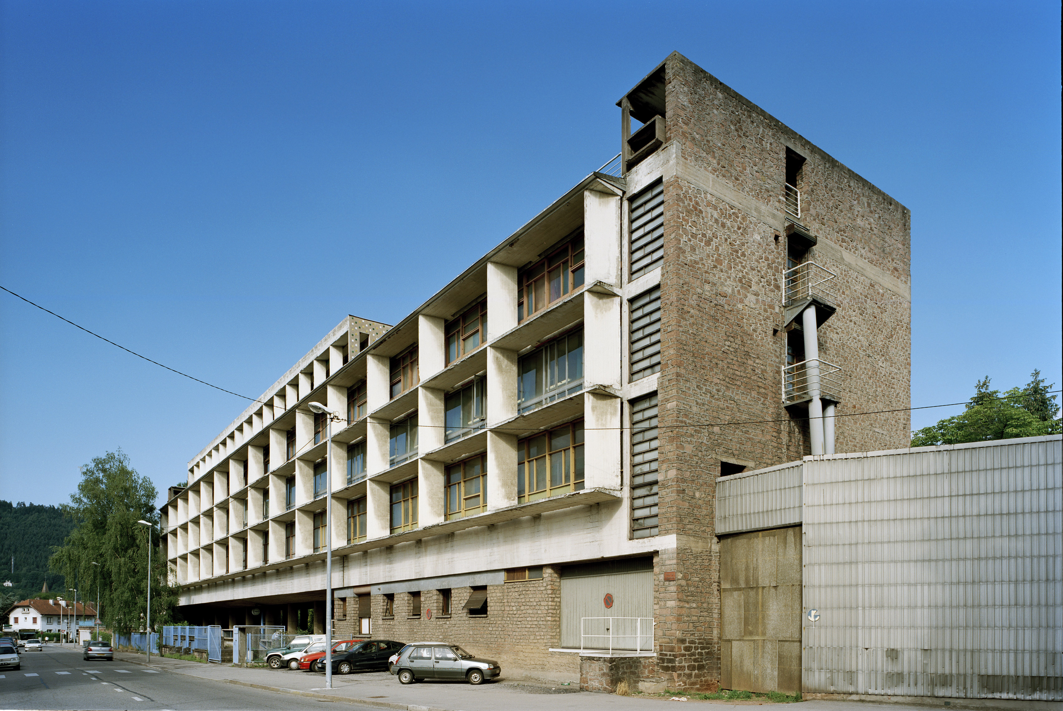 The Claude et Duval hosiery factory in Saint-Dié, its glazed main facade shaded by a concrete brise-soleil