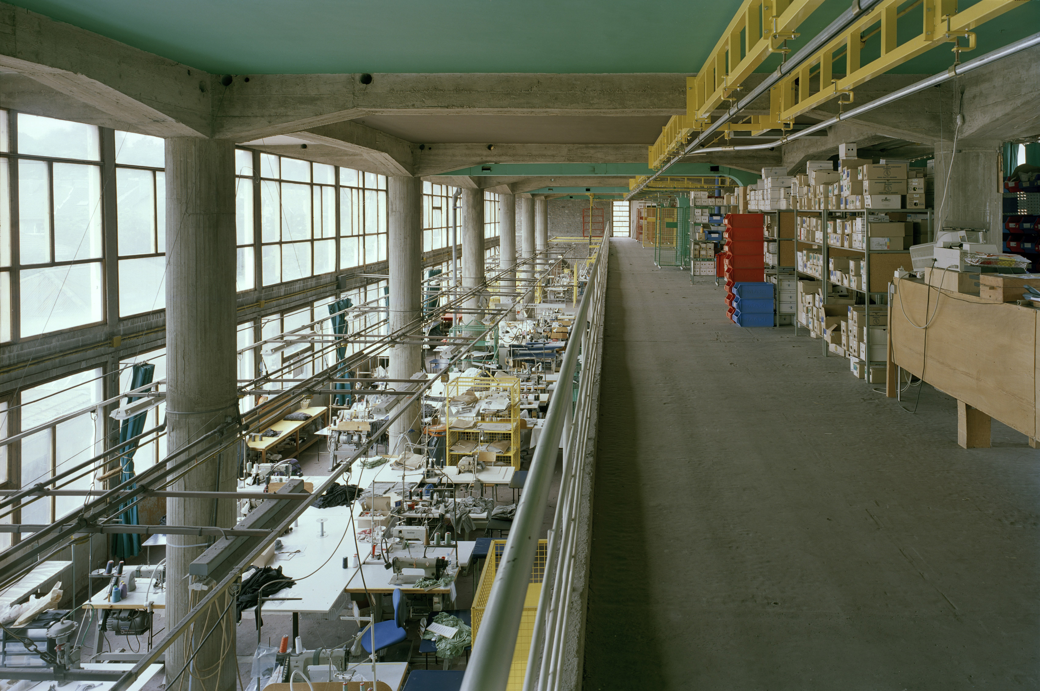 Interior of the Claude et Duval factory, with board-marked concrete and colourful painted accents