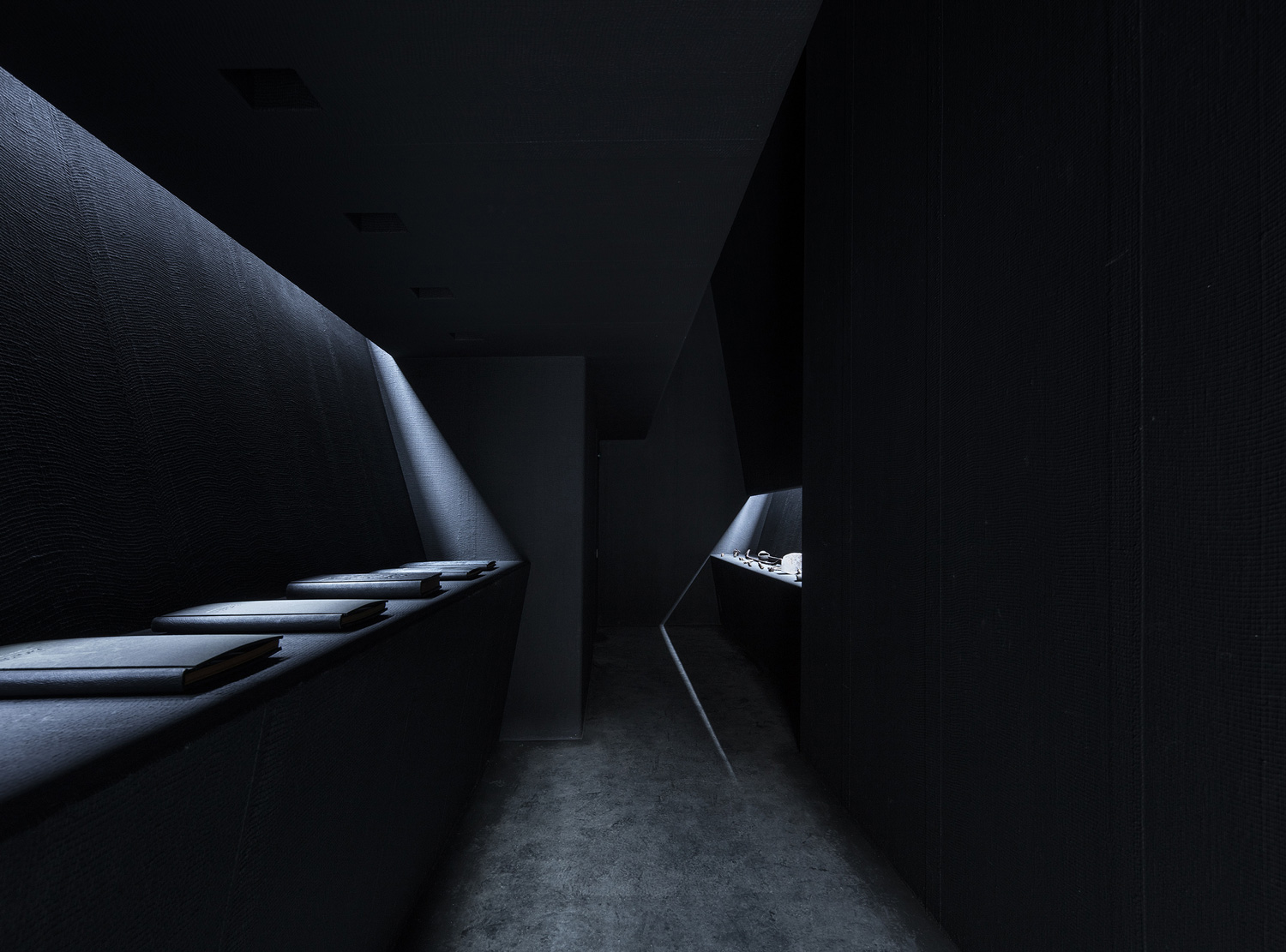 Inside the café: black room, pale tables, one long window on the gorge. Photography via Yellowtrace