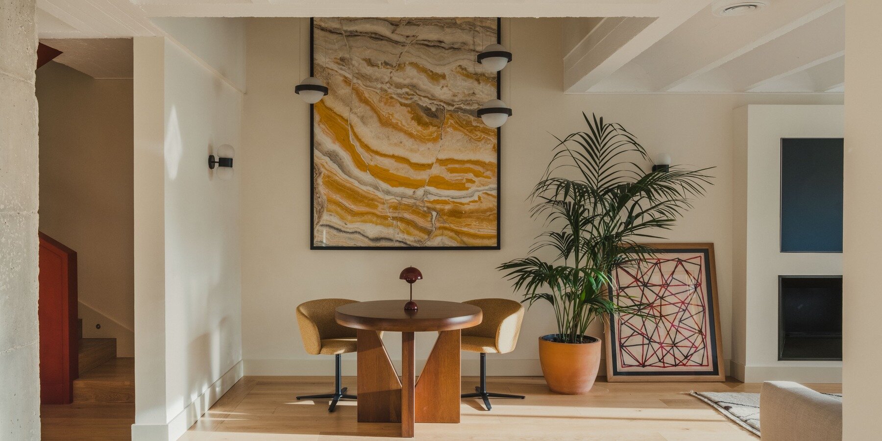 Renovated duplex interior with exposed concrete vaulted slabs overhead