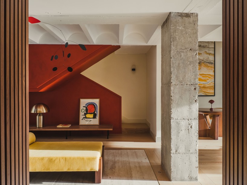Onyx Picasso marble panel rising through the double-height space