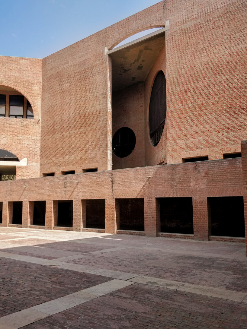 The circular openings and shaded corridors of the IIMA campus.