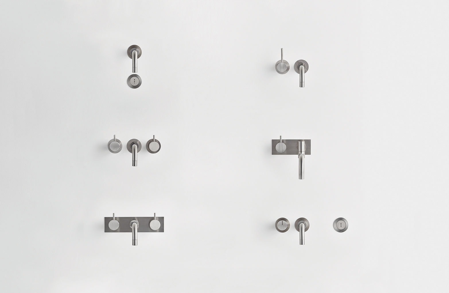 A VOLA wall-mounted mixer, with only the handles and spout coming through the surface